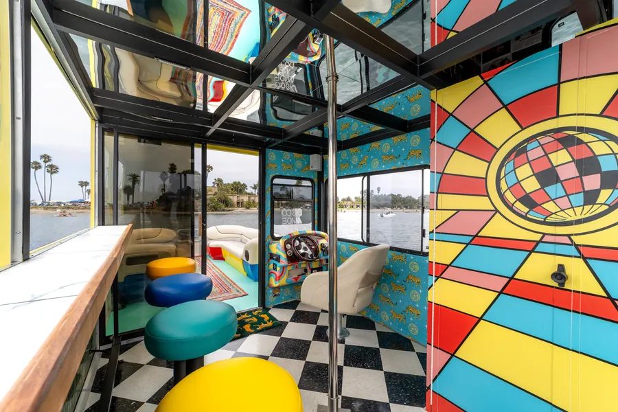 Disco Boat interior detail — leopard wall pattern and the colorful retro-wrapped helm