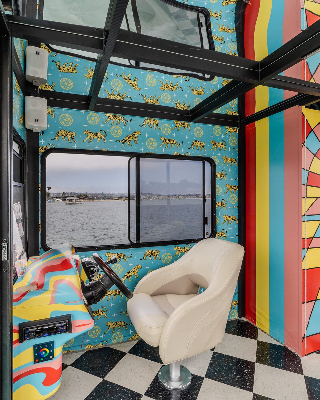 Disco Boat 1970s interior — psychedelic helm, leopard walls, checkerboard floor